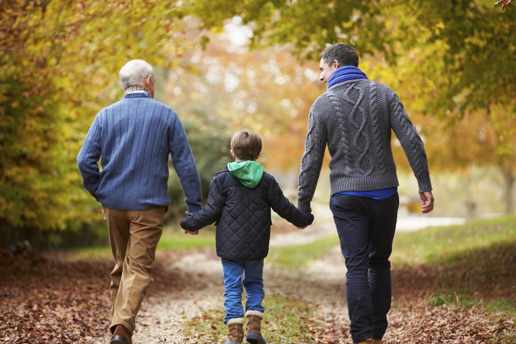 Rear View Of Male Multl Generation Family Walking On Path